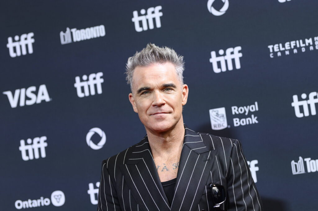 Singer Robbie Williams on a red carpet.