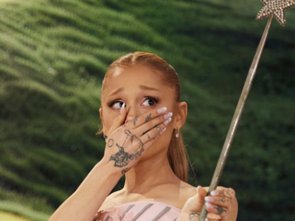 Ariana Grande looks shocked as she holds the original Glinda wand from the Wizard of Oz
