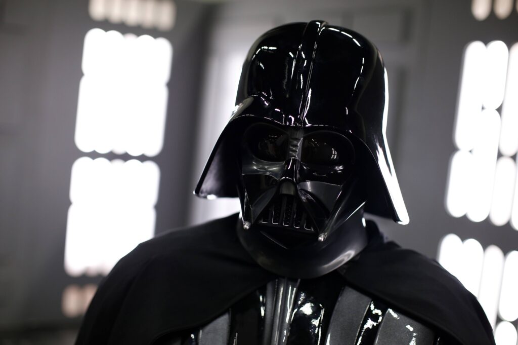 A woman has won a cash settlement after being compared to Darth Vader at work.